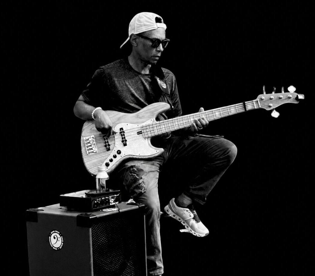 Man with bass and speaker sitting down