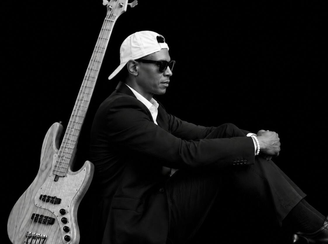 Guy with Bass on Back Guy sitting down with bass on back