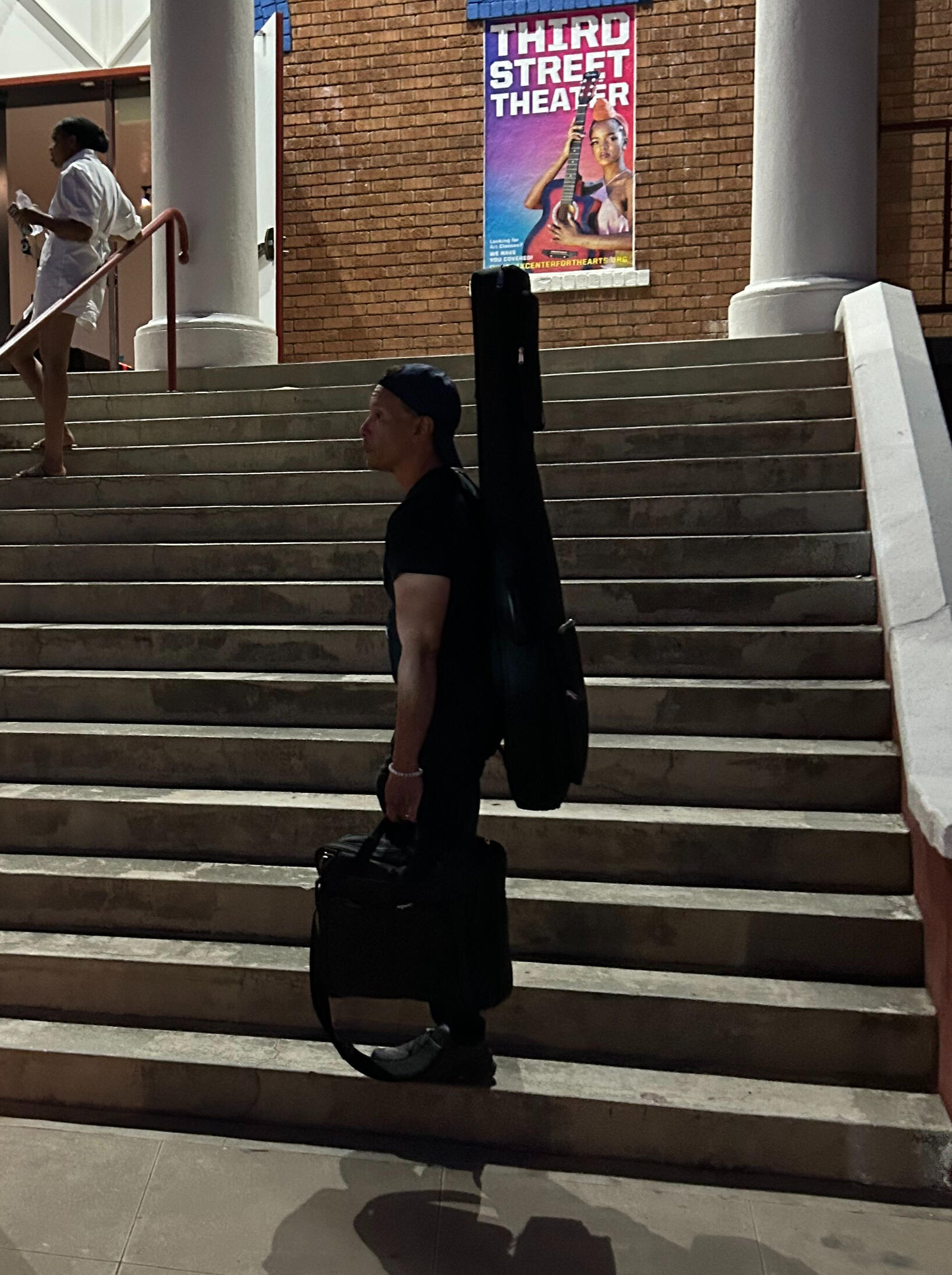 Man holding bag with bass on back